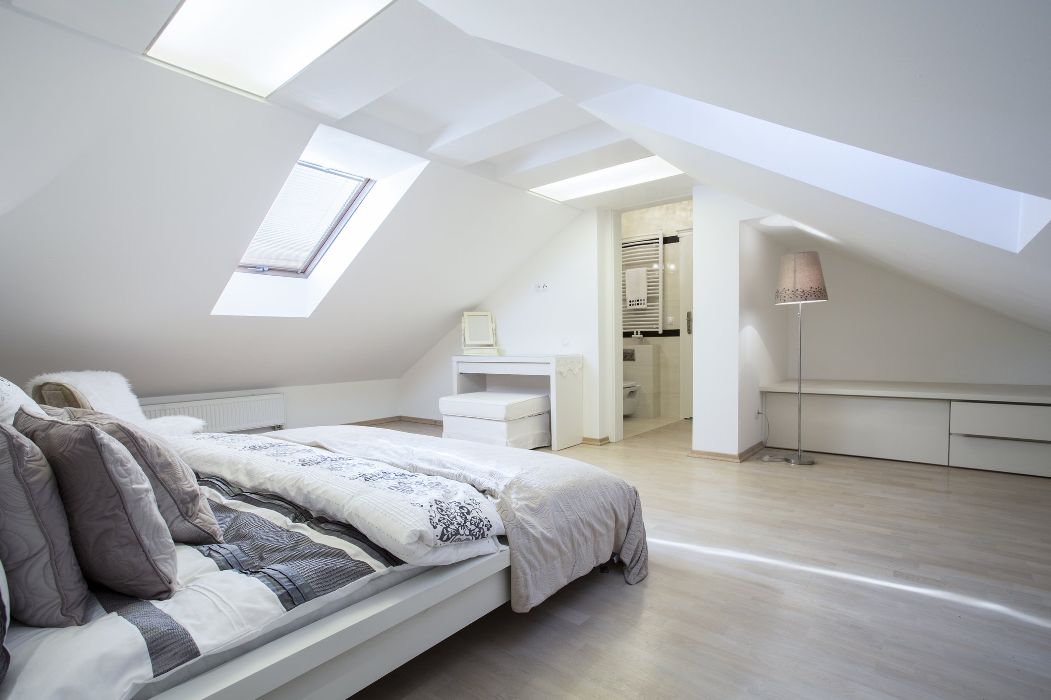 A bright modern loft conversion bedroom with skylights