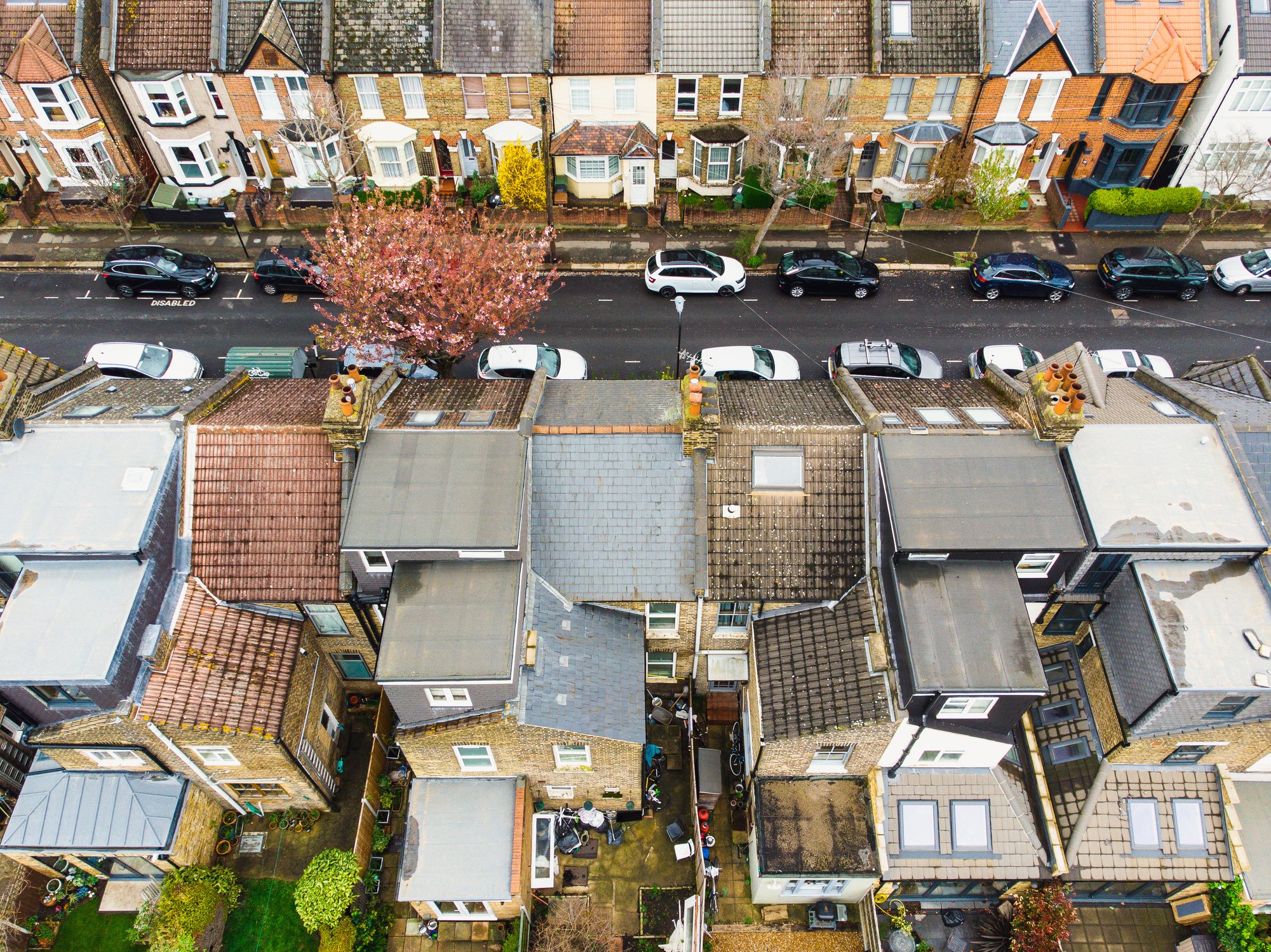 Aerial view of terraced houses in London showing varied extensions