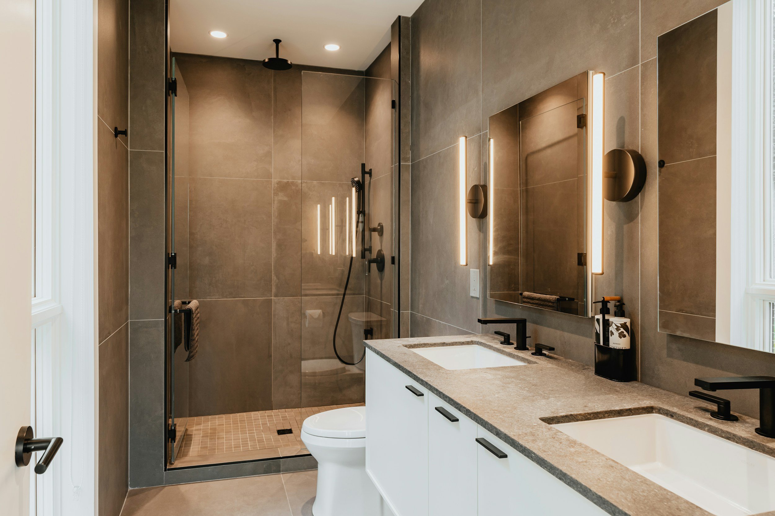 A contemporary luxury bathroom with double vanity