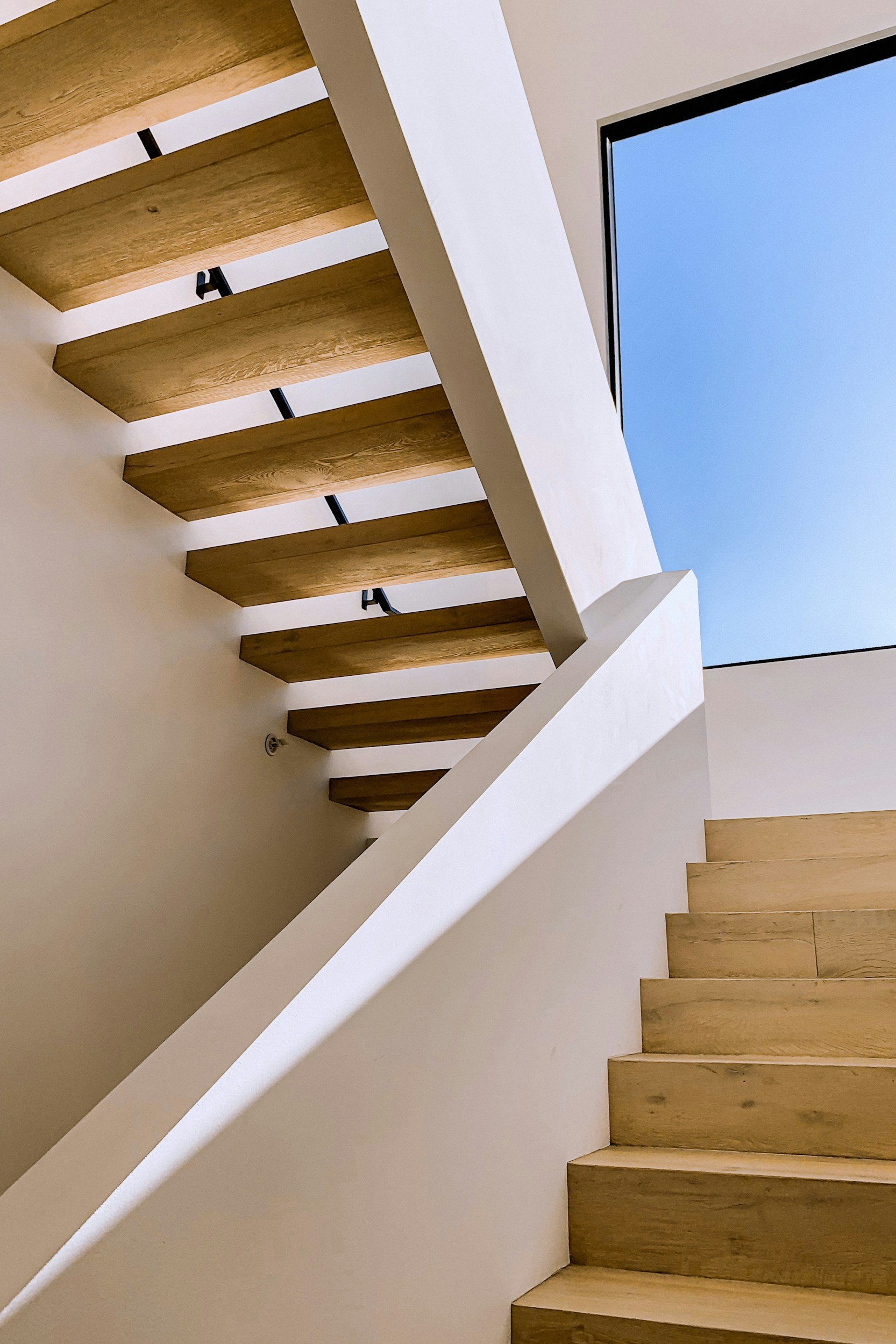A modern loft staircase with white railings