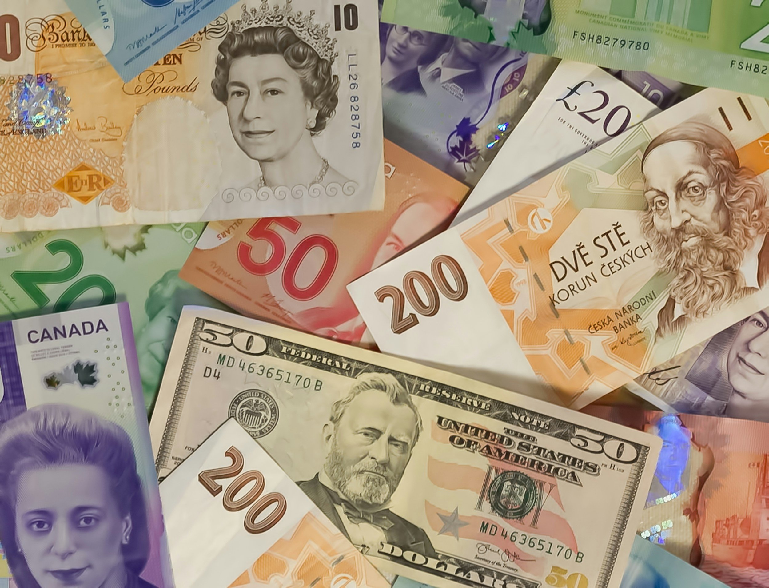 Stacked Euro banknotes and a calculator on a desk