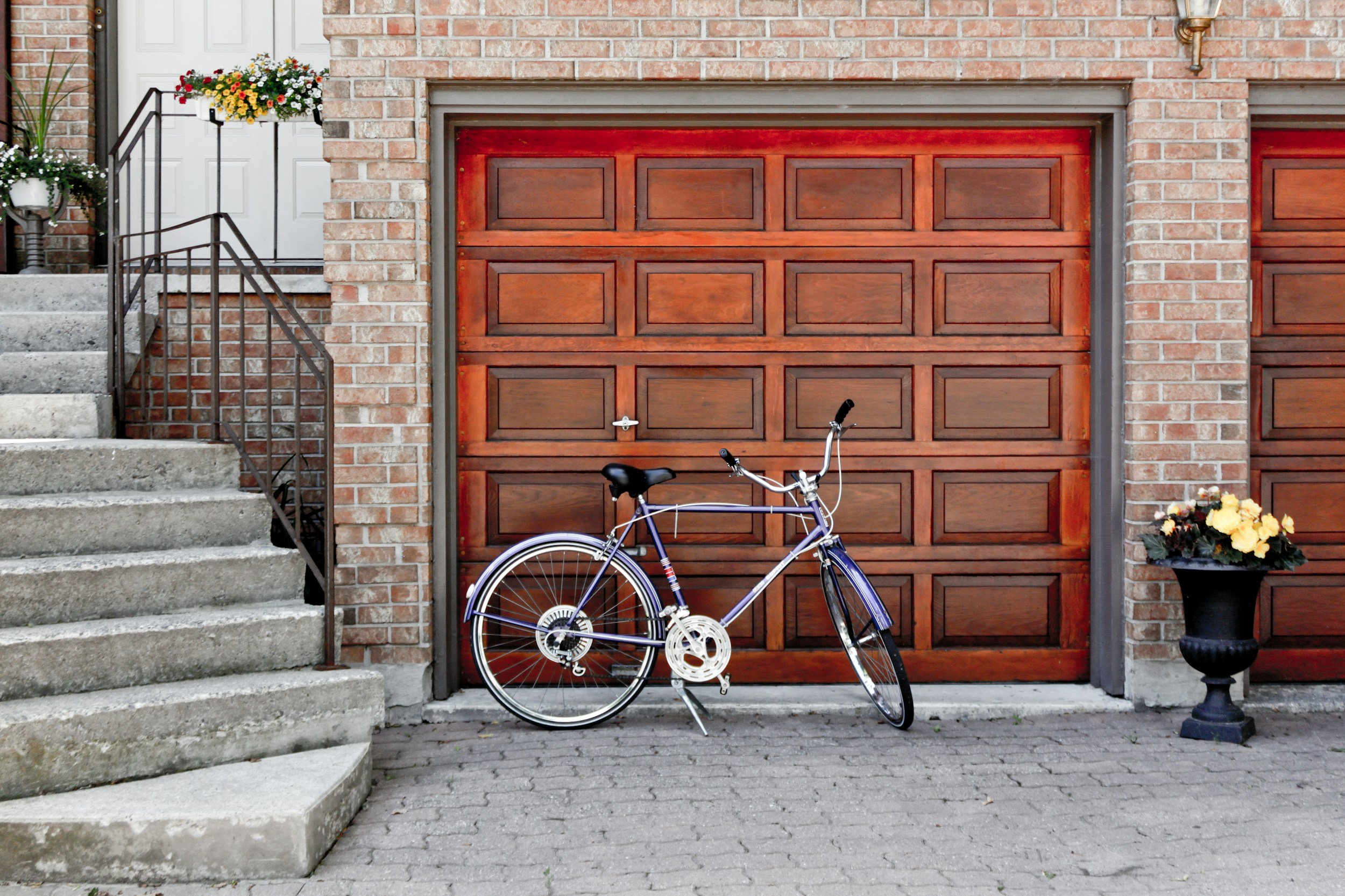 A garage interior with bicycles and storage preceding conversion