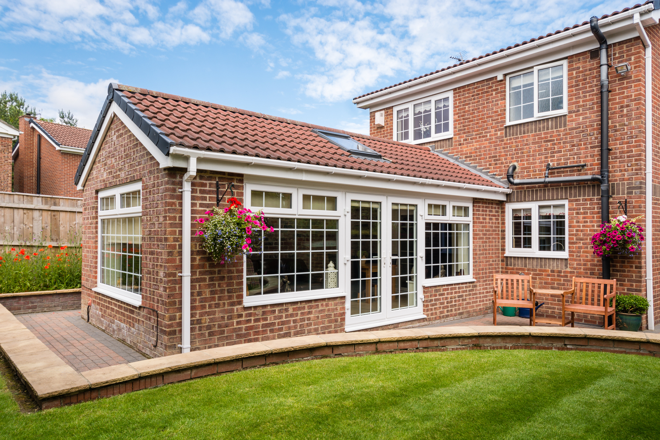 A brick house with a single-storey rear extension and glazed doors